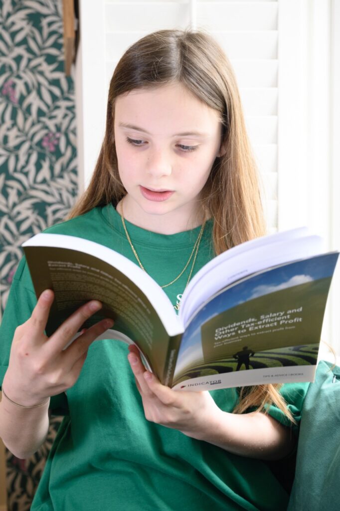 I need help with my accounts - girl reading an accountancy manual